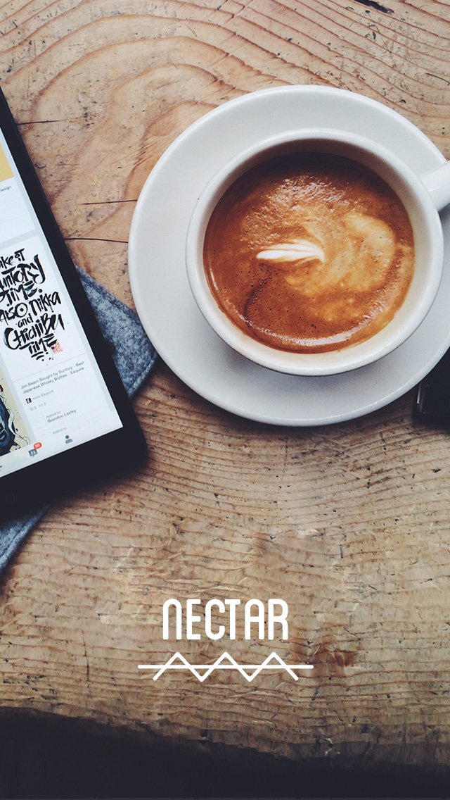 A cup of coffee on a white saucer placed on a rustic wooden table next to a smartphone.