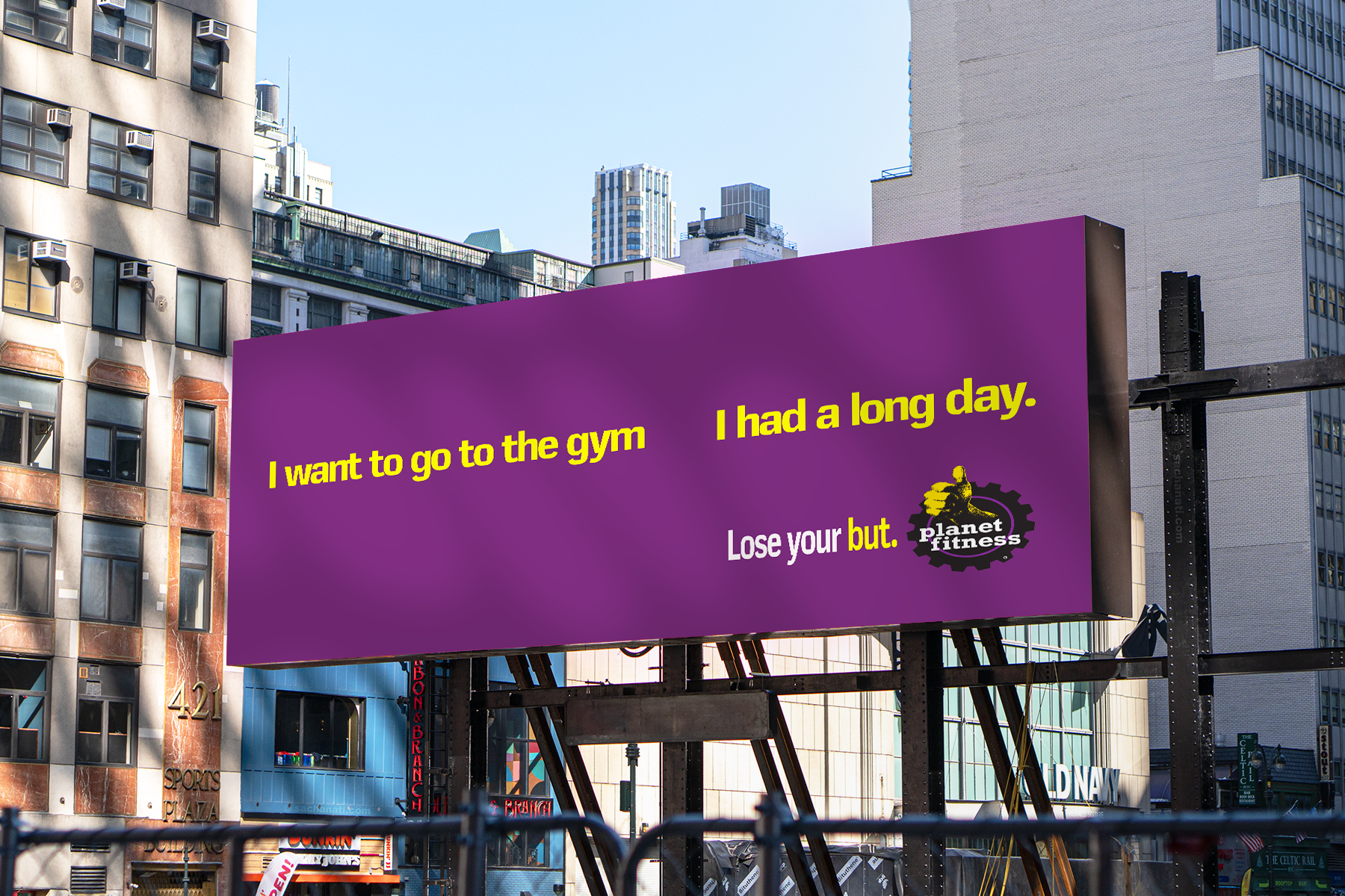 Billboard with purple background displaying text "I want to go to the gym" and "I had a long day" in yellow, "Lose your but" in white, and the Planet Fitness logo.