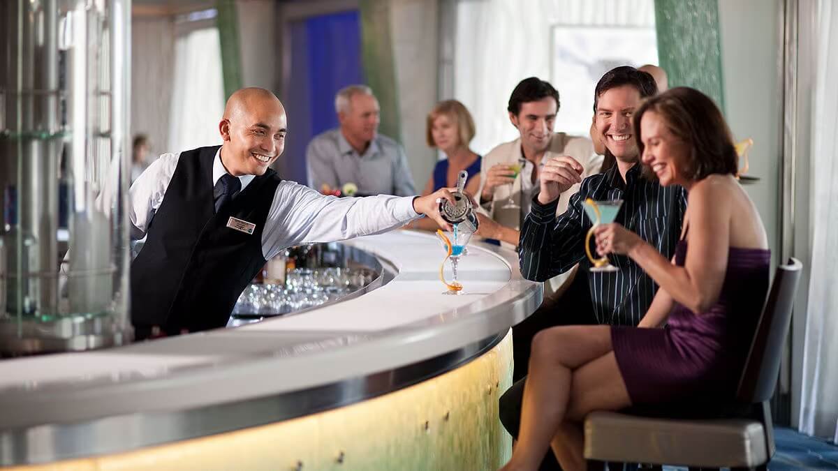 Bar on the Celebrity Equinox with bartender pouring a drink.