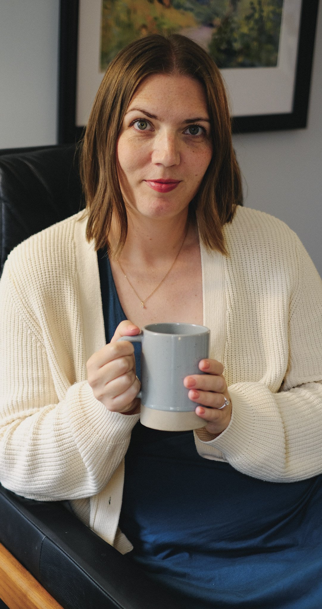 An image of Holly Boulanger holding a coffee cup representing her invitation to reach out for a free consultation before beginning therapy for religious trauma.
