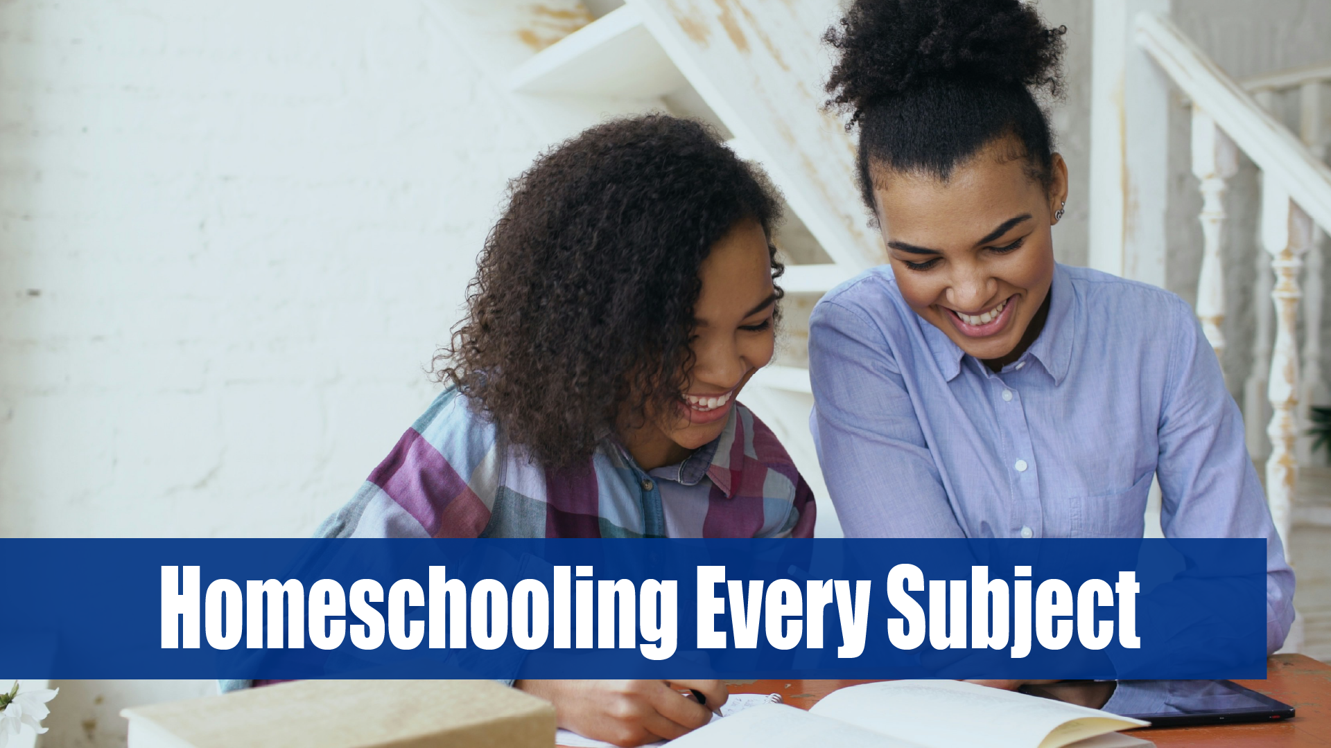 A mom with curly black hair helps her daughter study.