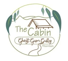 Logo with a stylized cabin roof, labeled "The Cabin Ghost Gum Gully Thornton," surrounded by leaves and a winding path.