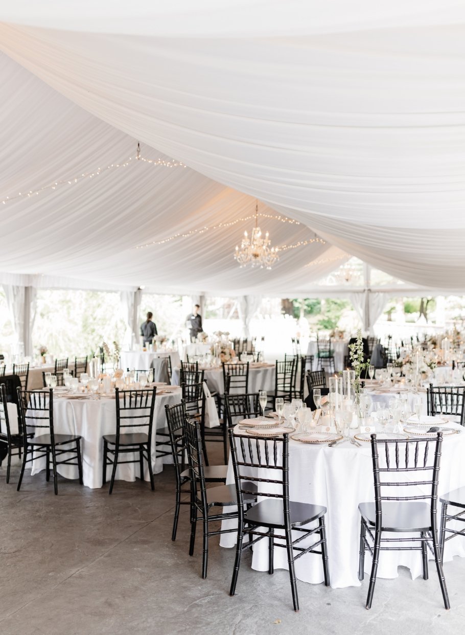 Under the elegant white wedding tent at Stone Mill Inn