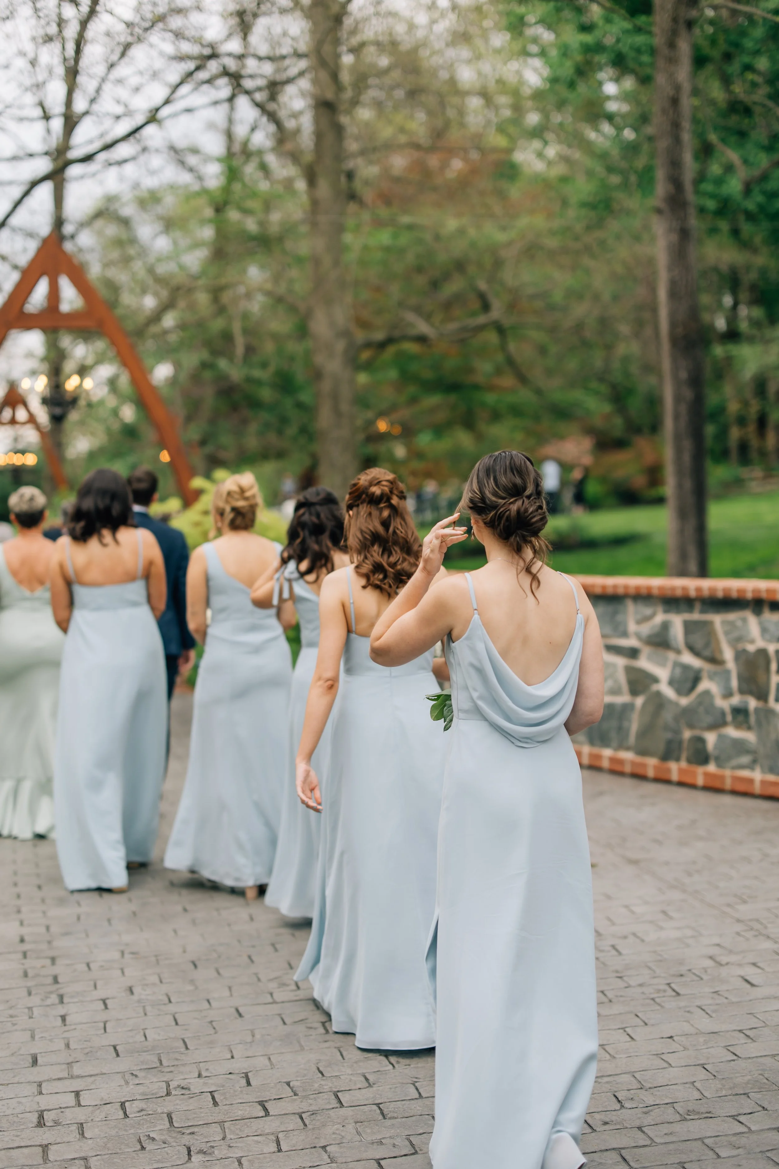 bridesmaids walking to romantic ceremony site