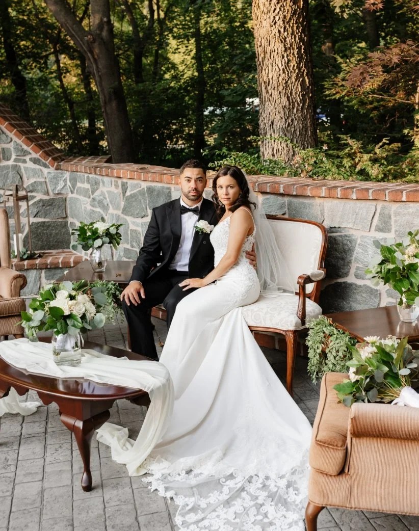 Wedding couple on outdoor sofa on elegant stone patio