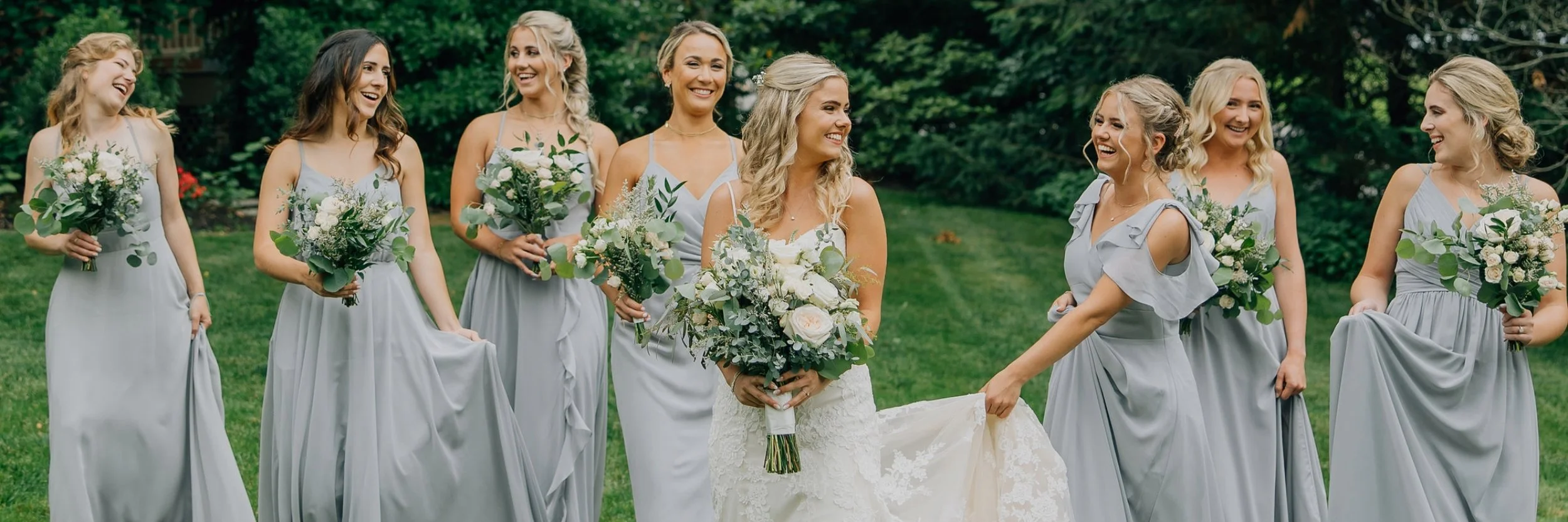 Bridal party smiling and laughing outside