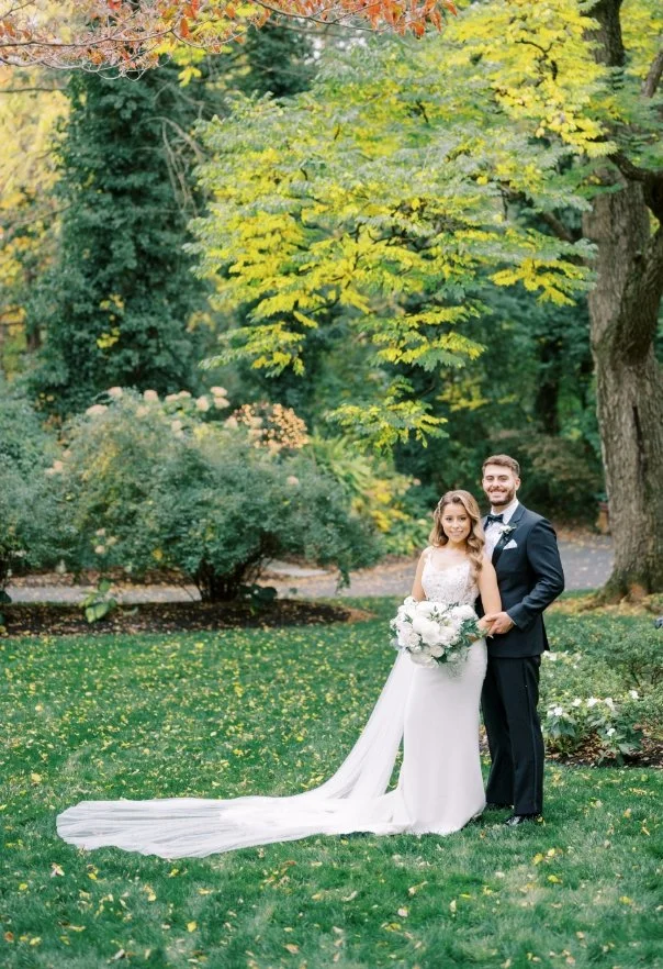 Bride and Groom posing outside in greenery