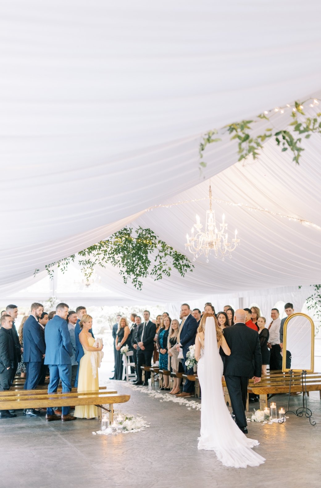 Bride walking down the white tewnt aisle