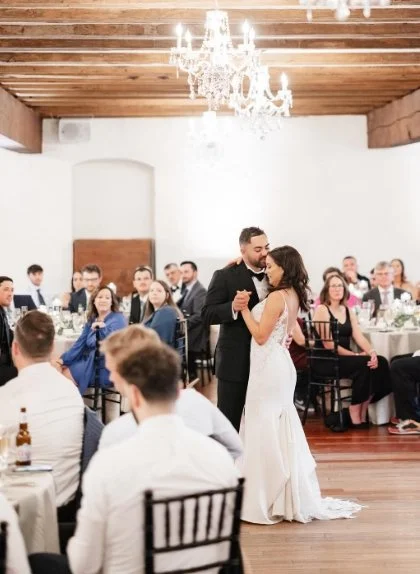 Couple dancing inside the Mill under chandelier