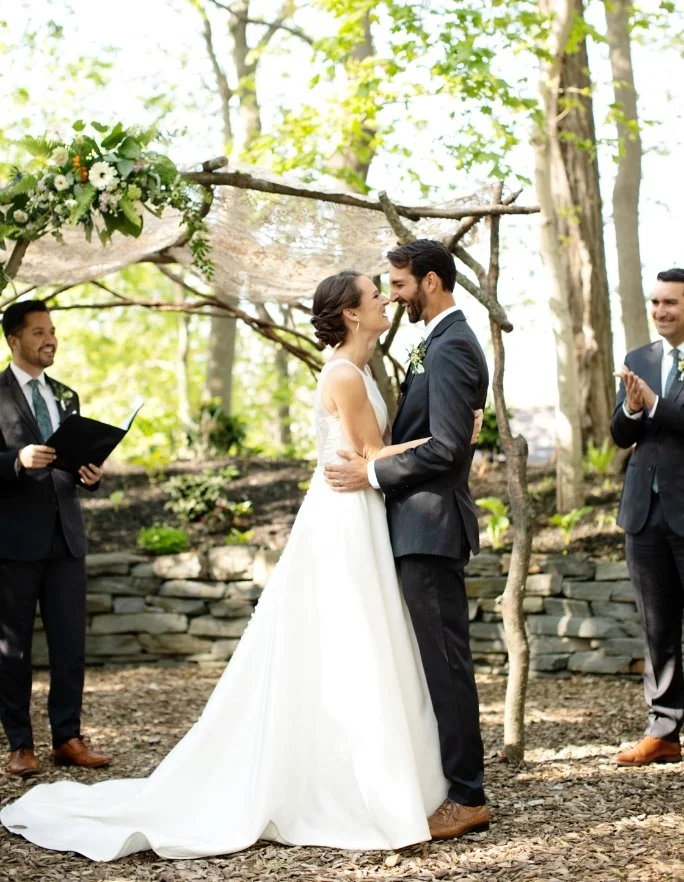 First kiss under the wooden alter in the woods