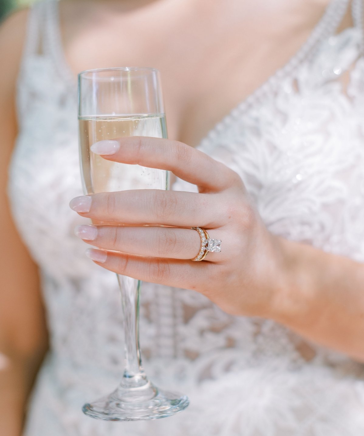 Bride holding glass of champagne