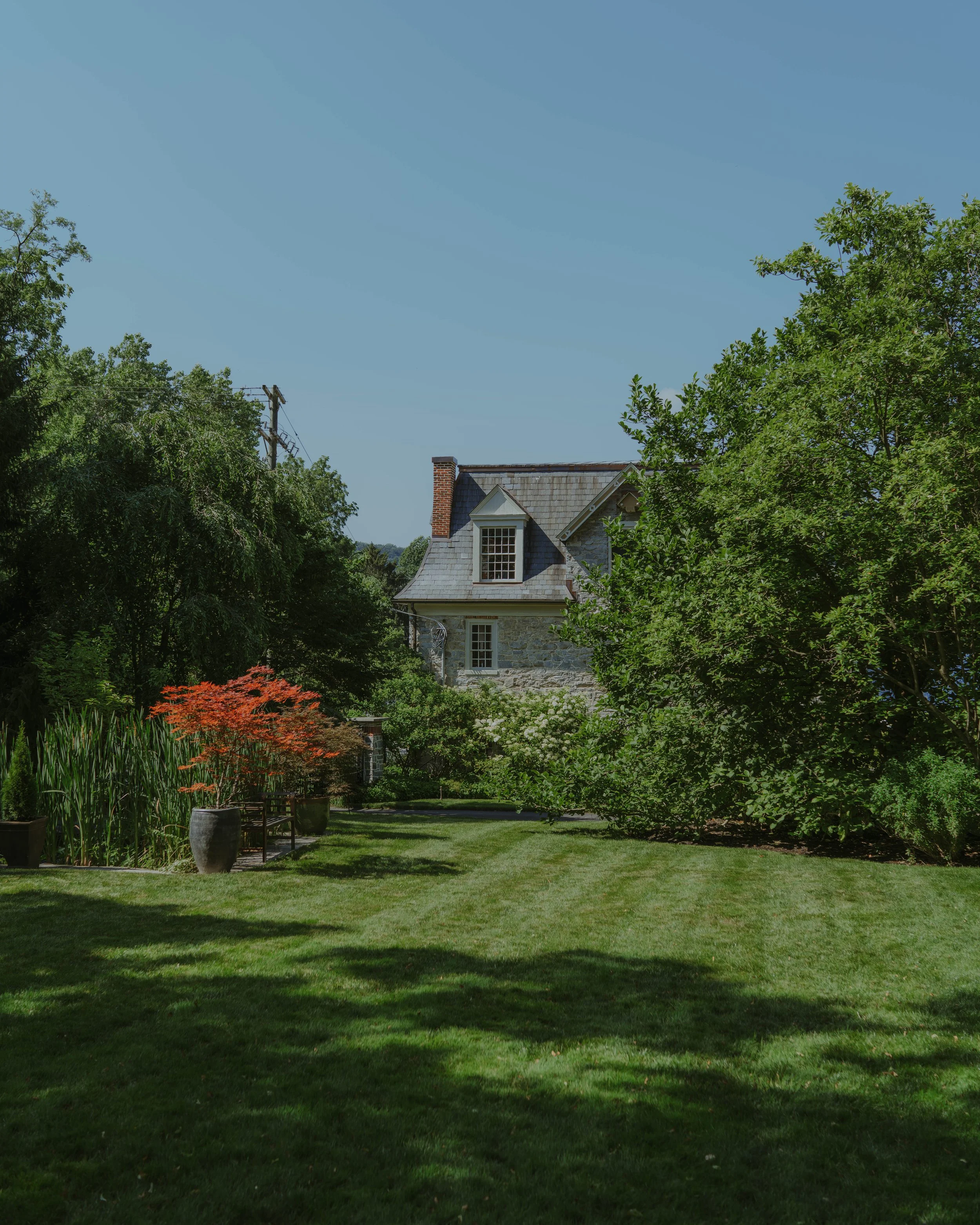 the lawn and pond at stone mill inn