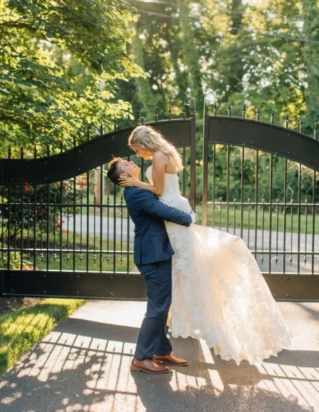Bride and groom in front of antique gate