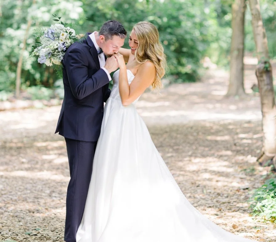Groom kissing bride's hand