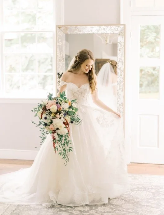 Bride admiring gown in mirror