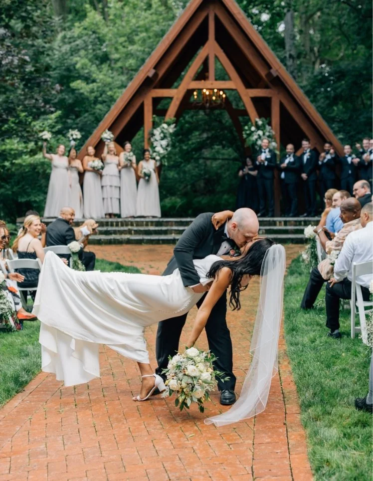 Groom dipping bride for first kiss at the Abbey