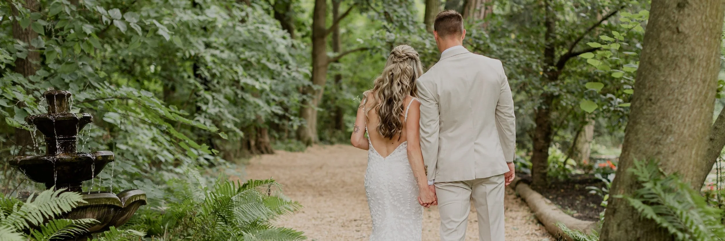 Wedding couple walking through the woods