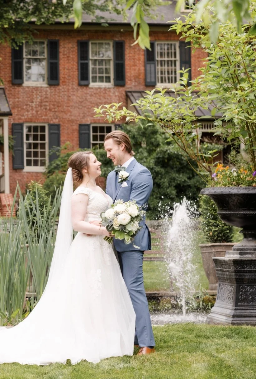 Bride and Groom in front the the Inn and fountain
