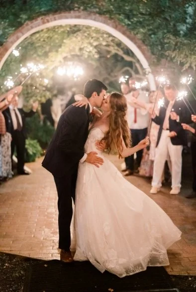 Couple kissing at night under the moongate with sparklers