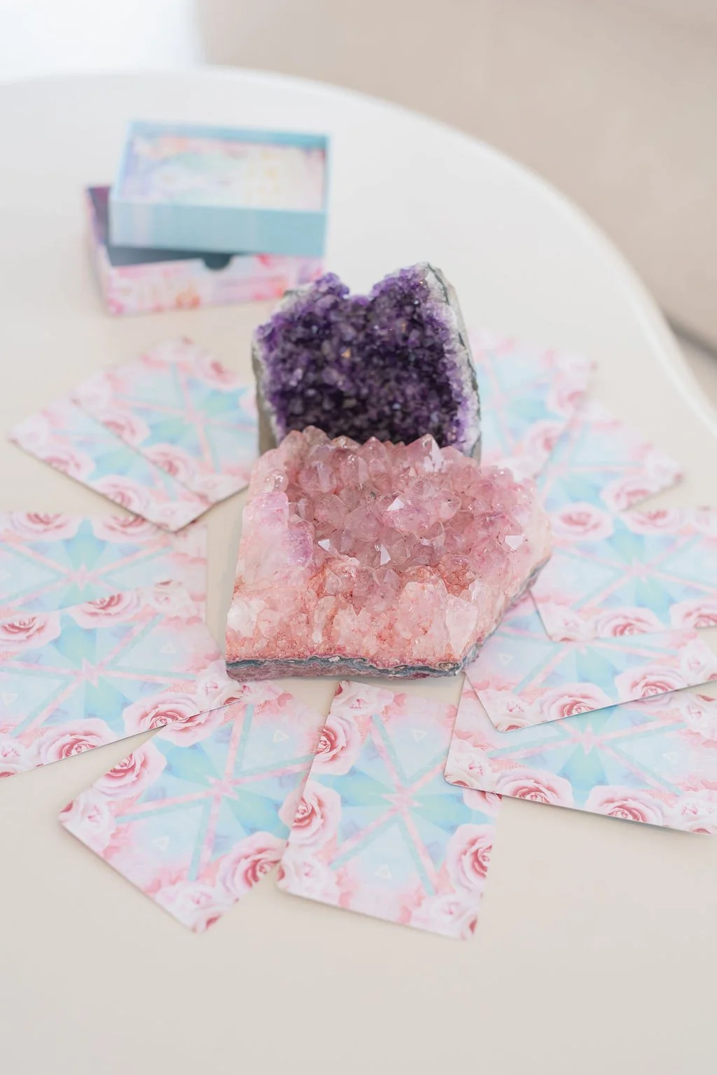Amethyst and rose quartz crystals on oracle cards, tools Stefanie uses in intuitive coaching