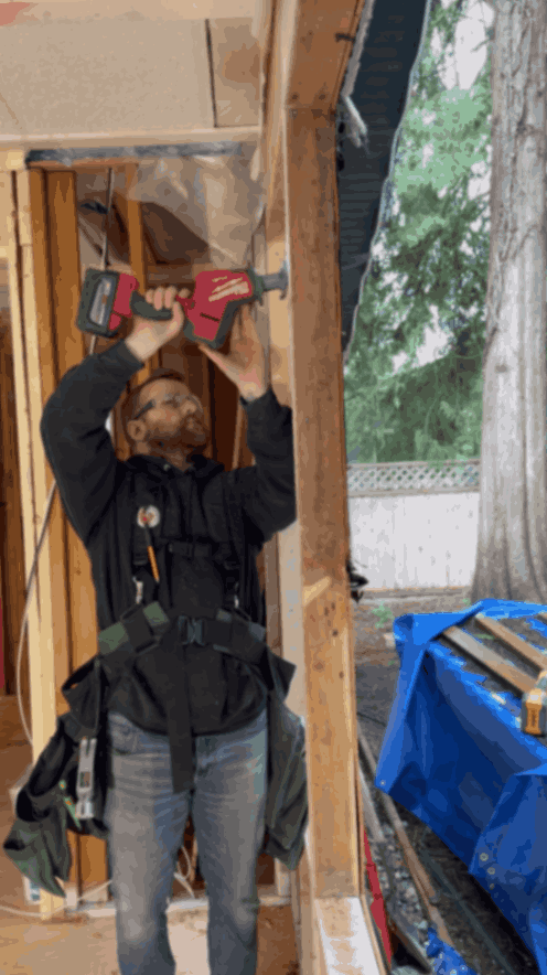 Oakhaven owner Cody cutting wood framing with reciprocating saw