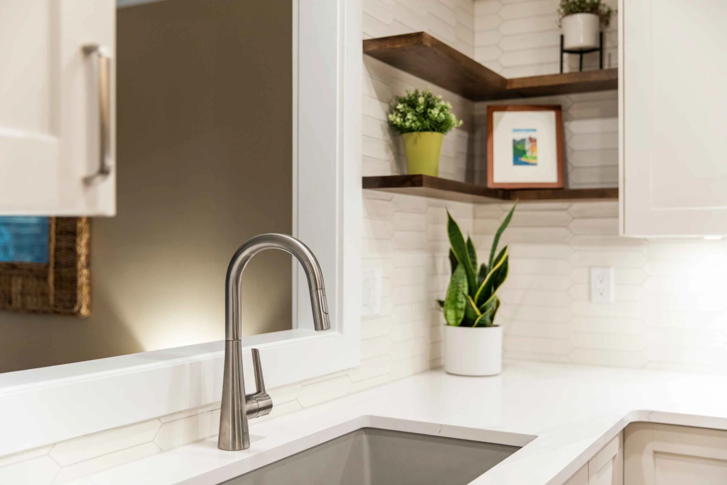 white kitchen corner with open wood shelving decor and stainless steel sink