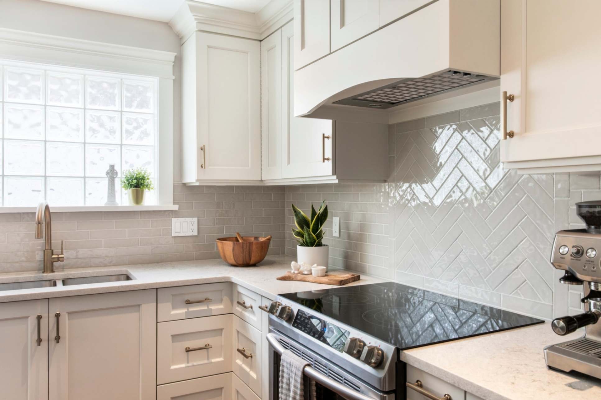 white farmhouse kitchen with herringbone tile and white cupboards