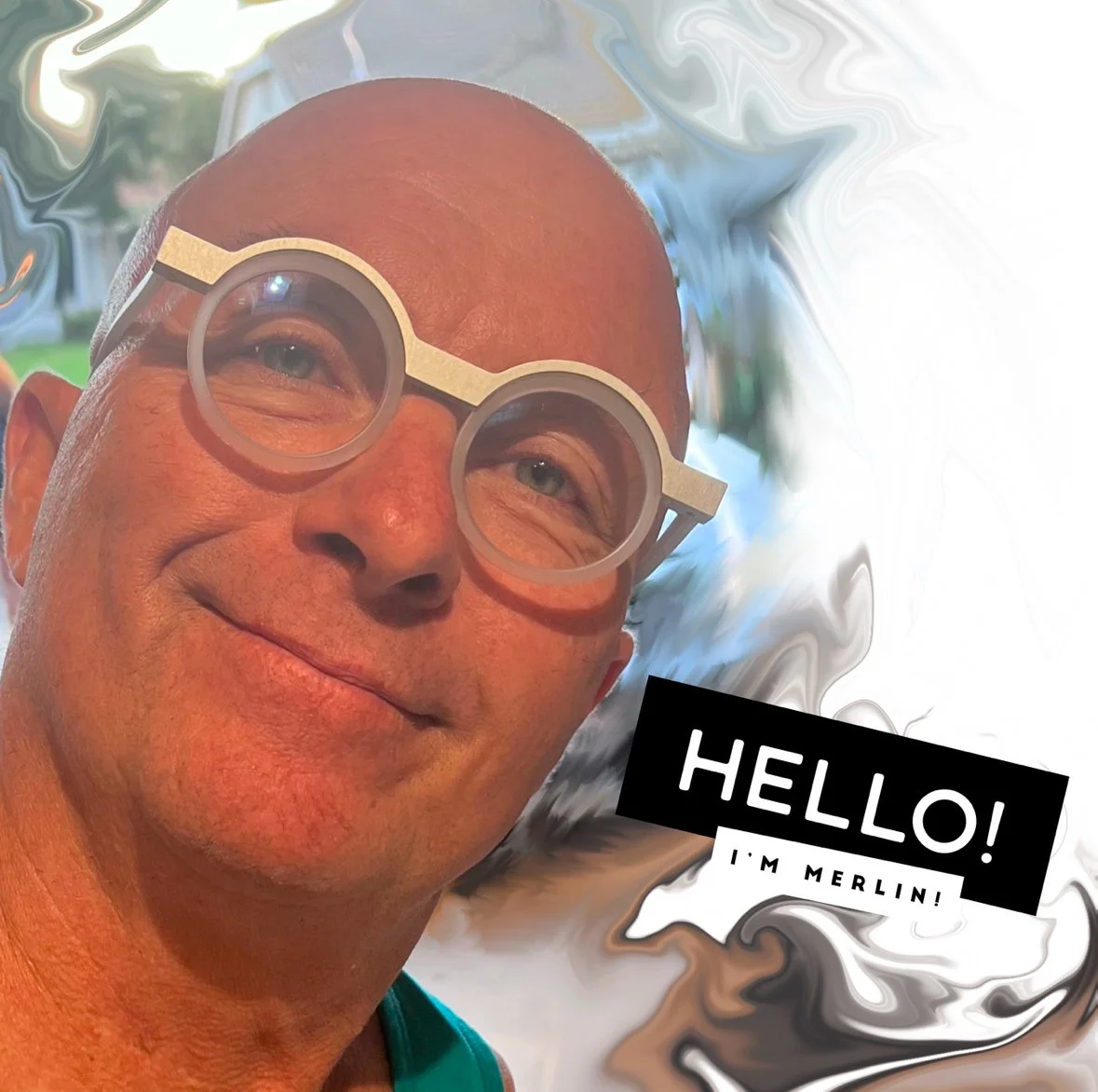 A man with a bald head wearing large, round glasses smiling at the camera, with a background of swirling colors and a speech bubble saying 'HELLO! I'M MERLIN!'.