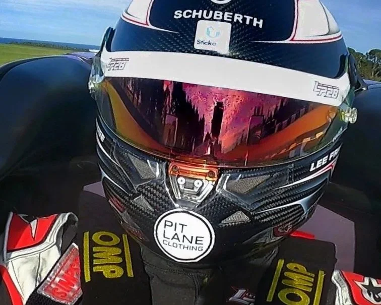 Close-up of a Formula race car in motion with visible sponsor logos and number 28.
