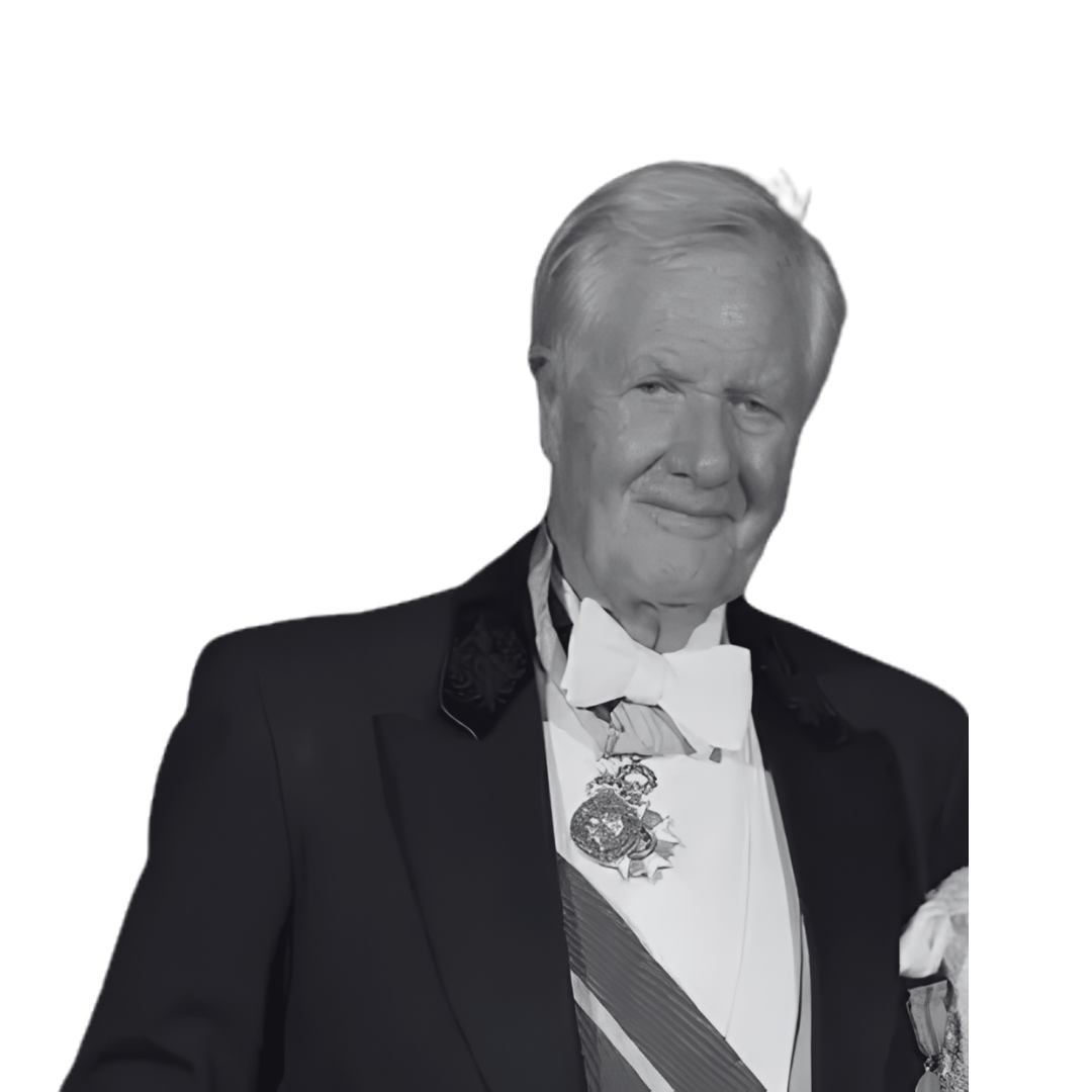 Black and white photo of an older man in a tuxedo with medals, wearing a bow tie, smiling.