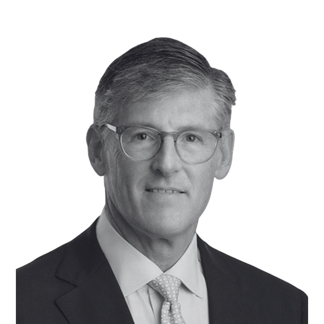 Black and white professional headshot of a man wearing glasses, a suit, dress shirt, and tie, smiling slightly.
