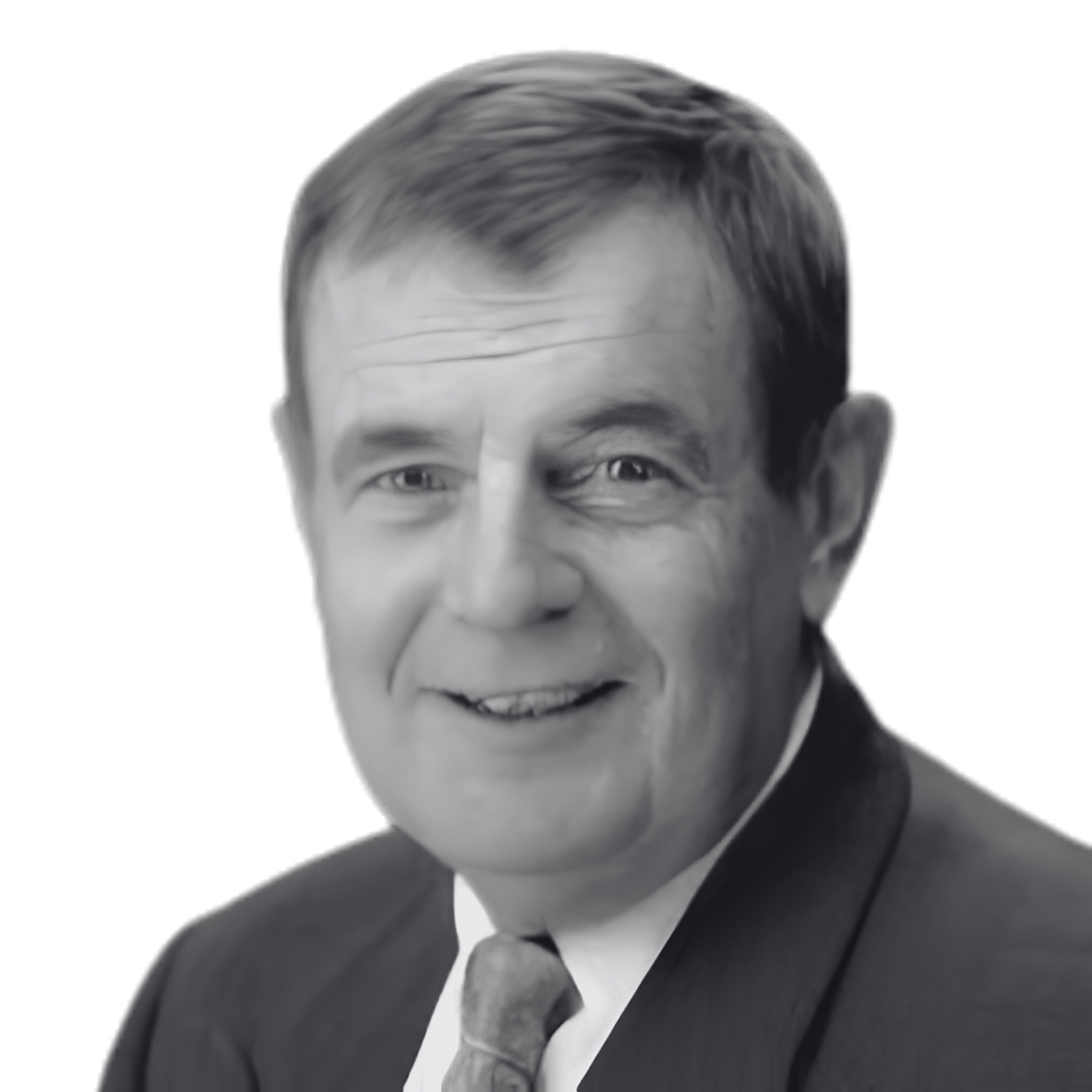Black and white photograph of a middle-aged man in a suit and tie, smiling.