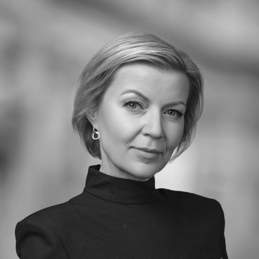 Black and white portrait of a woman with short, styled hair wearing a high-neck top and hoop earrings.