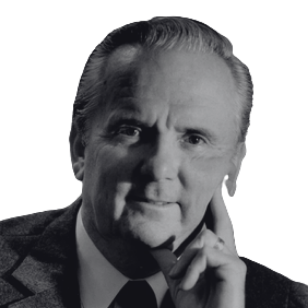 Black and white portrait of a man with neatly combed hair, wearing a suit, tie, and plaid jacket, posing thoughtfully with his hand near his chin.