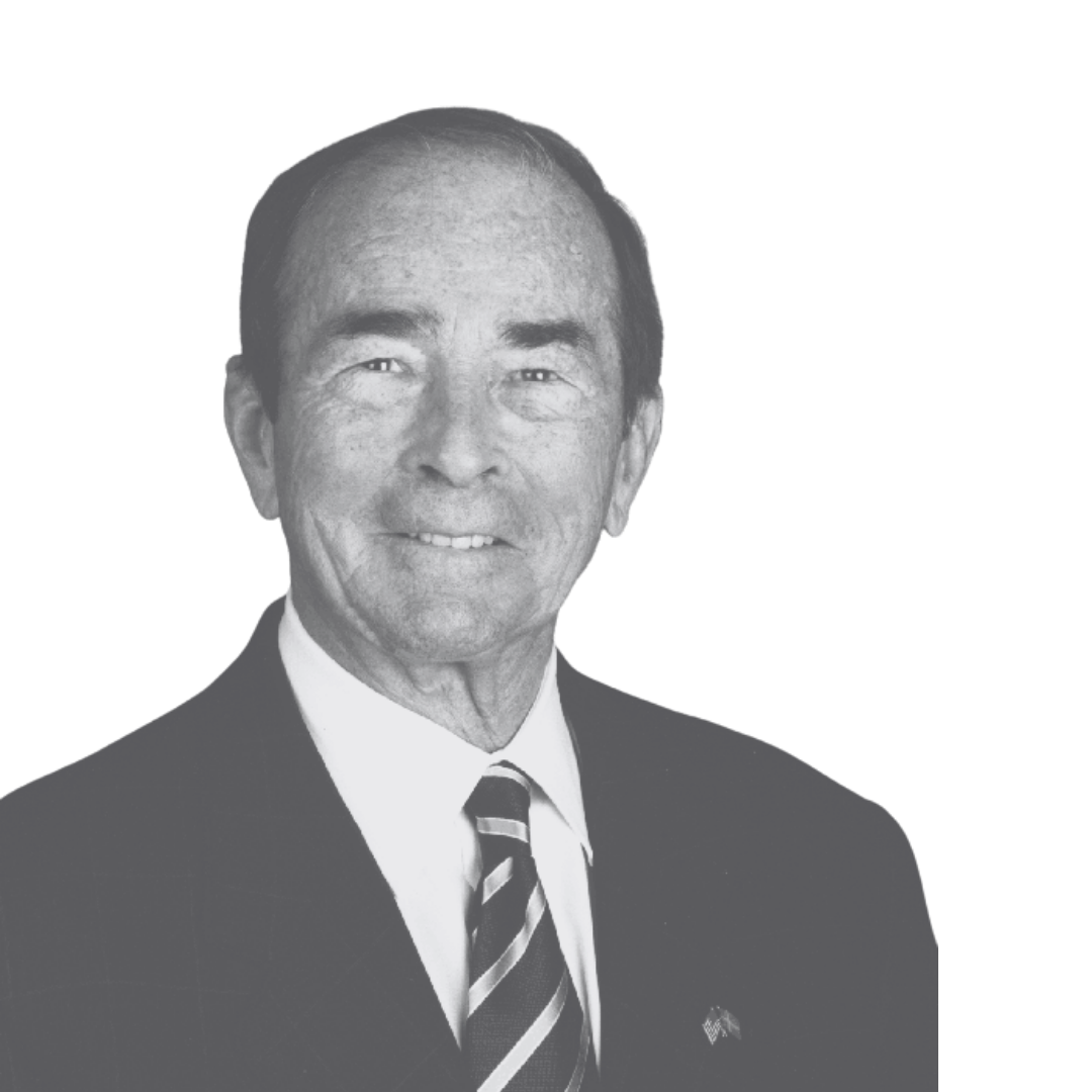 Black and white portrait of a middle-aged man with short hair, wearing a suit, dress shirt, and a striped tie.
