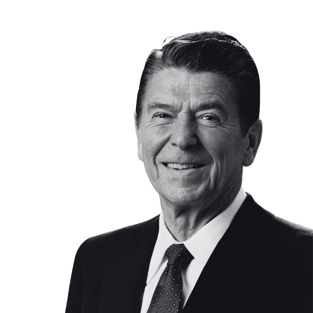 Black and white portrait of an elderly man smiling, wearing a suit and tie.