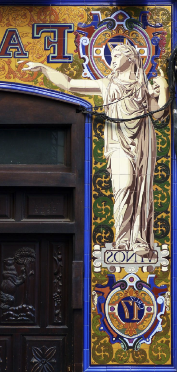 Colorful decorative tile mural featuring a classical statue of a woman with outstretched arm, surrounded by ornate patterns and the word "VINTAGE" on a scroll at the bottom.