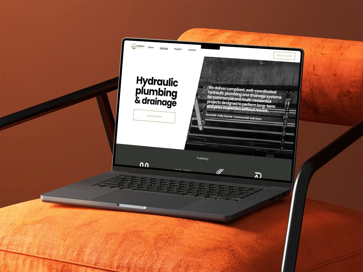 Laptop mockup on an orange chair showing the services page of a plumber website built as a modern trades website.