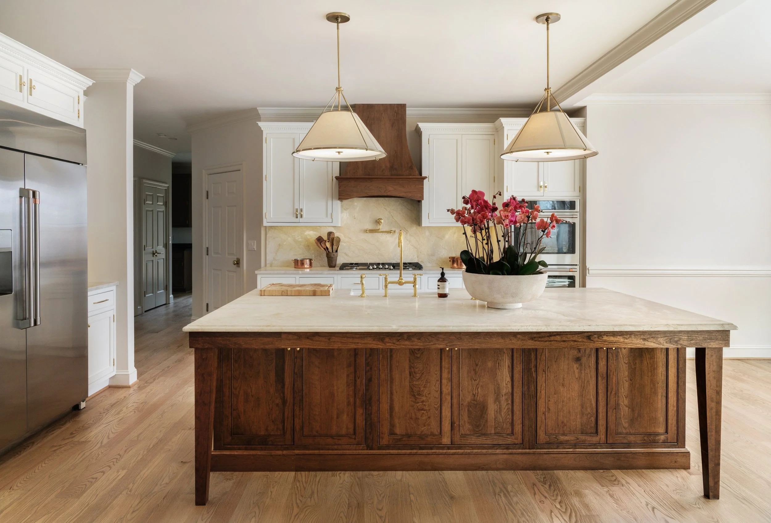 Custom kitchen remodel in Charlottesville, VA designed by Erin Stushek of Stushek Design, featuring a wood island with quartzite counter and brass fixtures.