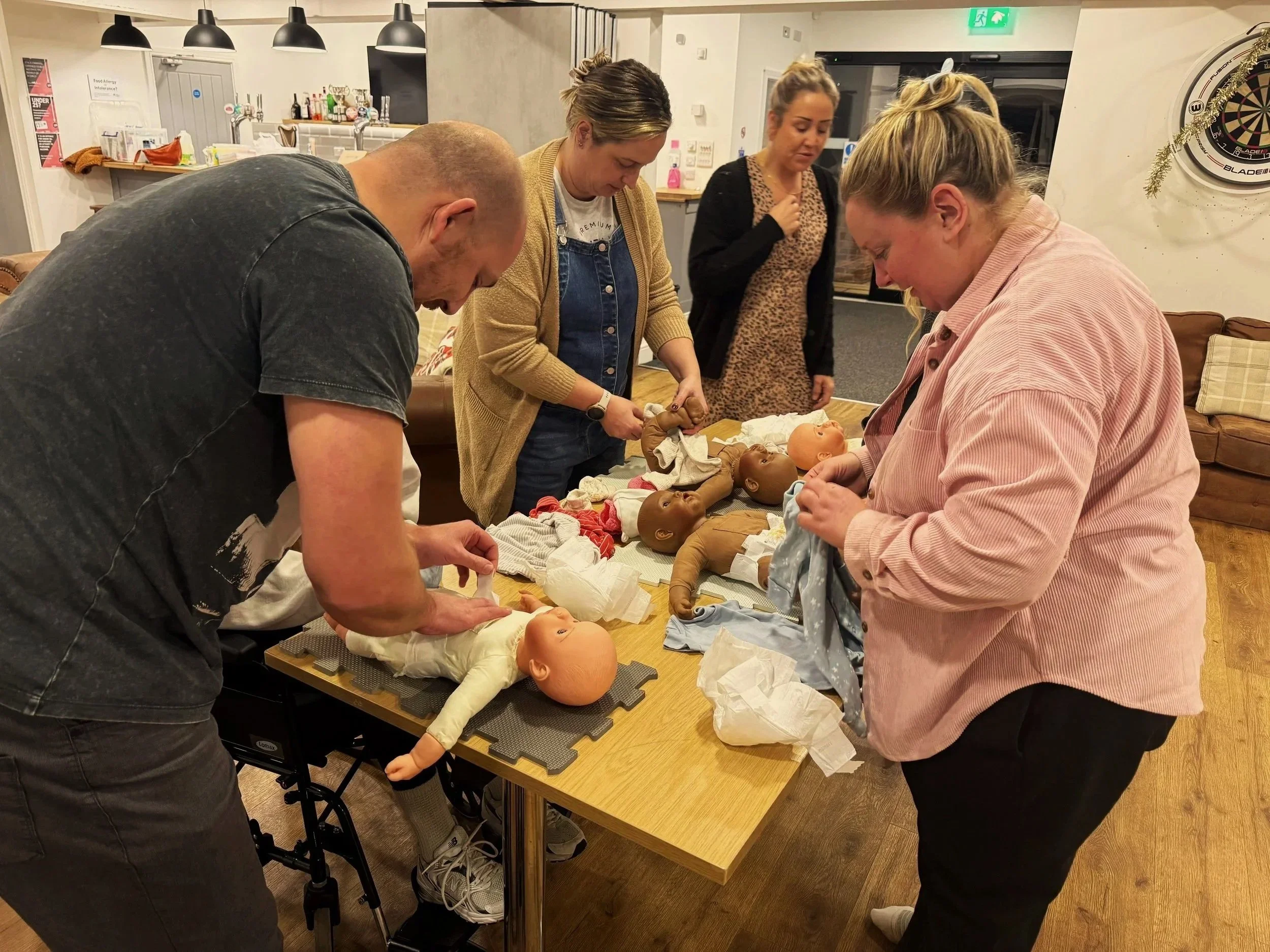 Jo leading a draeesing baby session in a group of parents