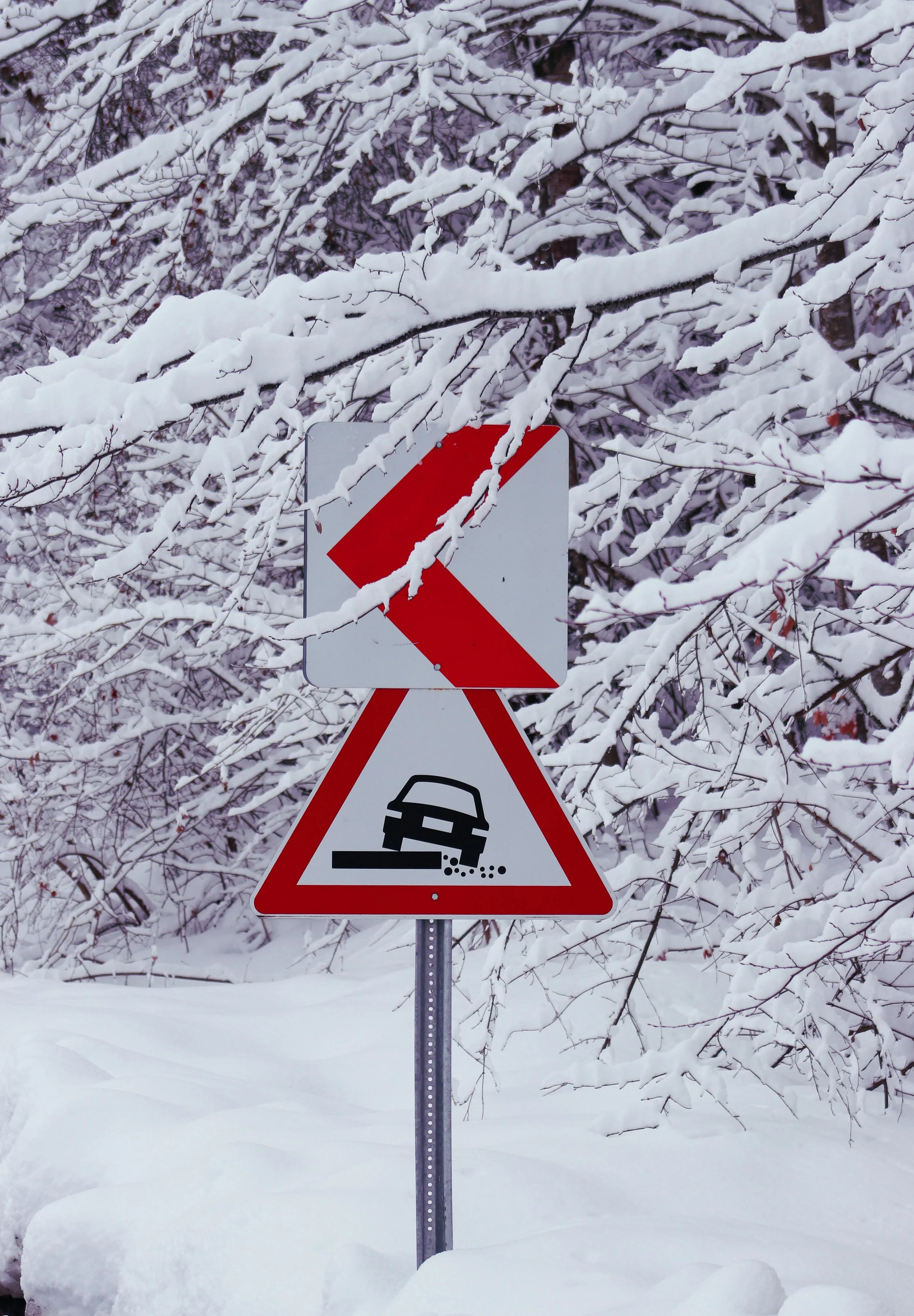 Snow-covered road warning sign symbolizing survival mode and staying alert in stressful situations