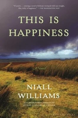 A book cover titled 'This Is Happiness' by Niall Williams, featuring a landscape of grassy fields and a cloudy sky.