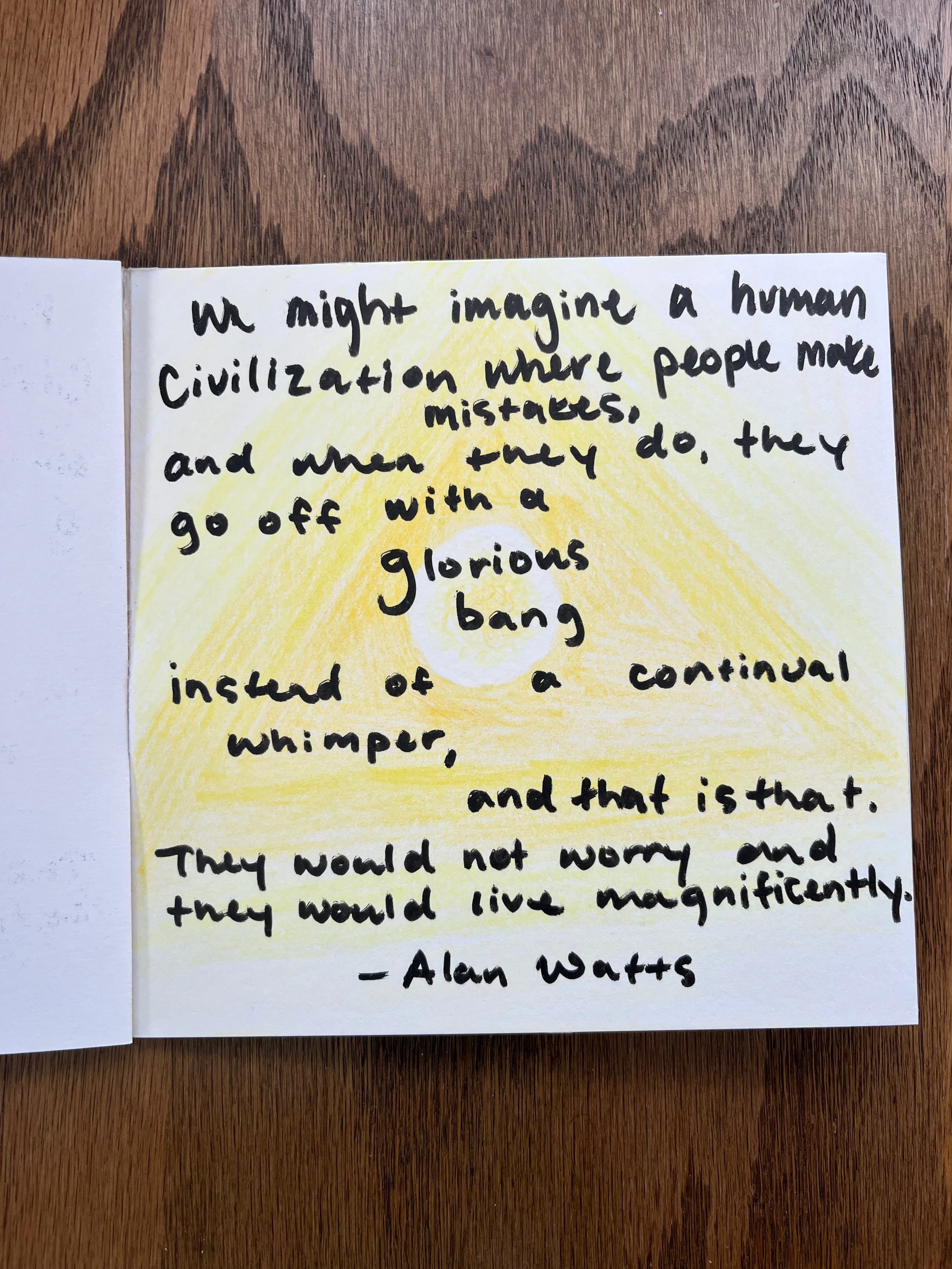 Handwritten quote on white paper with a yellow background, on a wooden surface. The quote is by Alan Watts and discusses human civilization and peace.