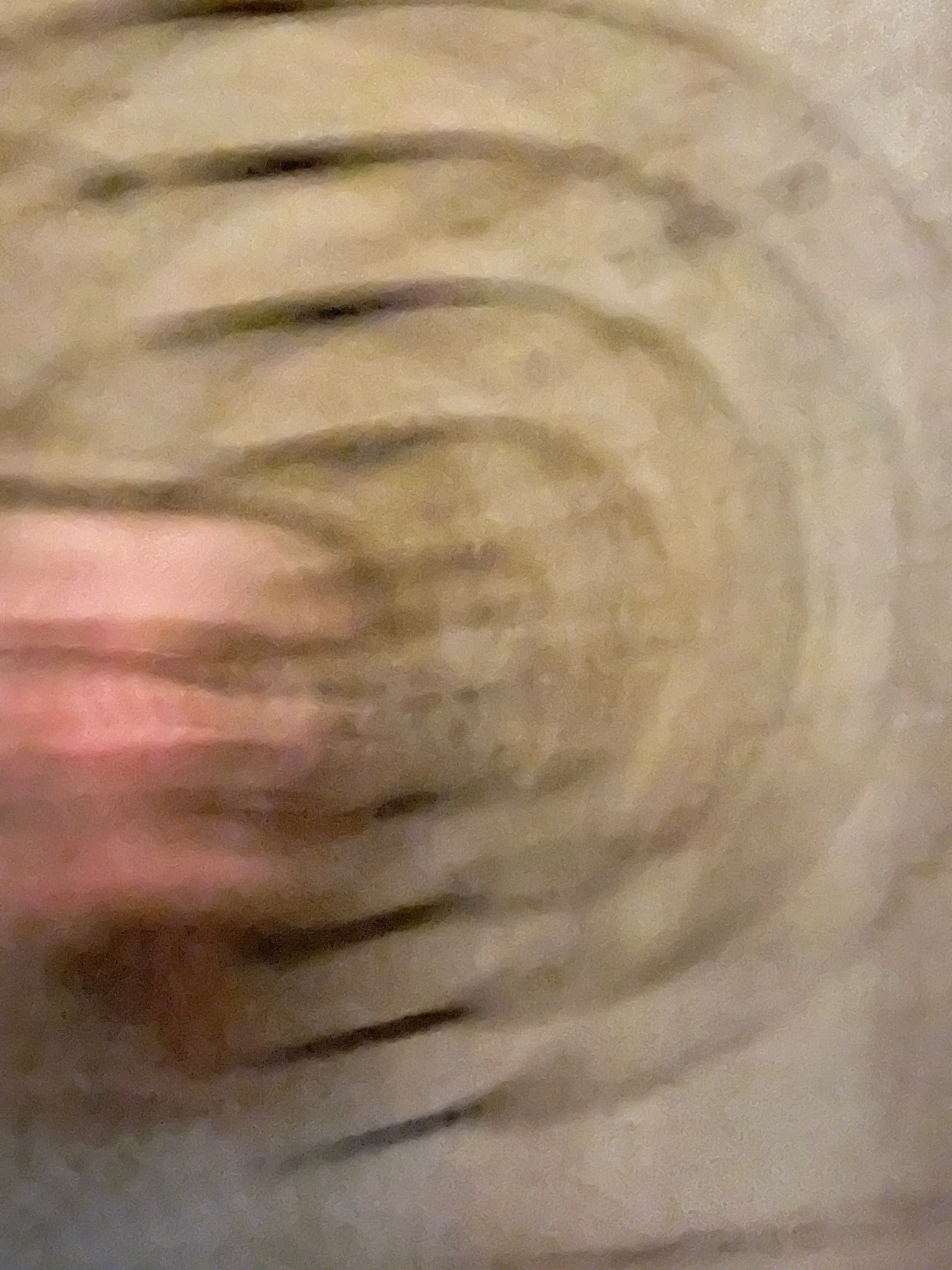 Close-up of a zebra's face, showing its black and white striped pattern and part of its eye.