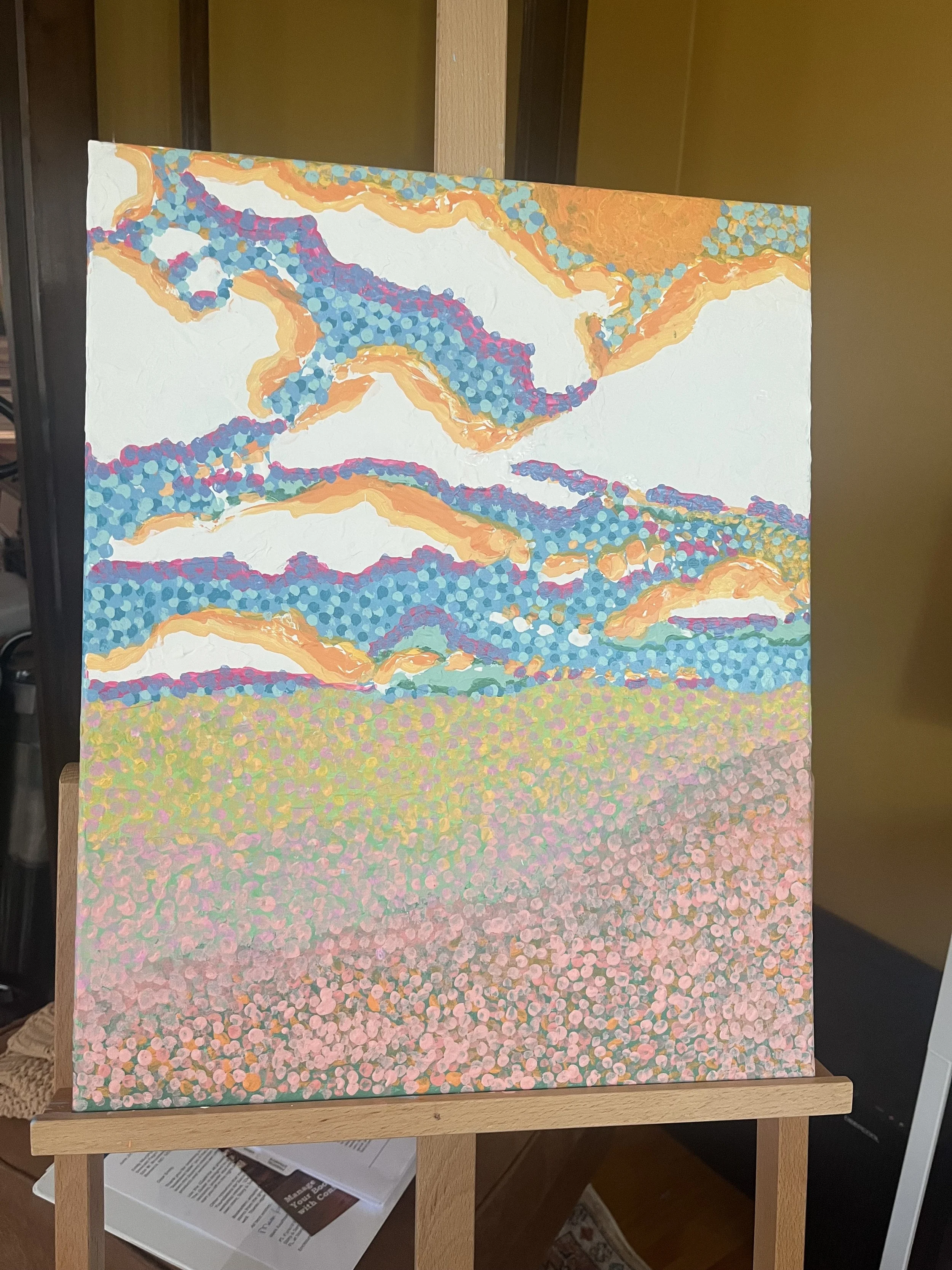 Abstract landscape painting with pink, blue, orange, and green colors, resembling sky, clouds, and field.