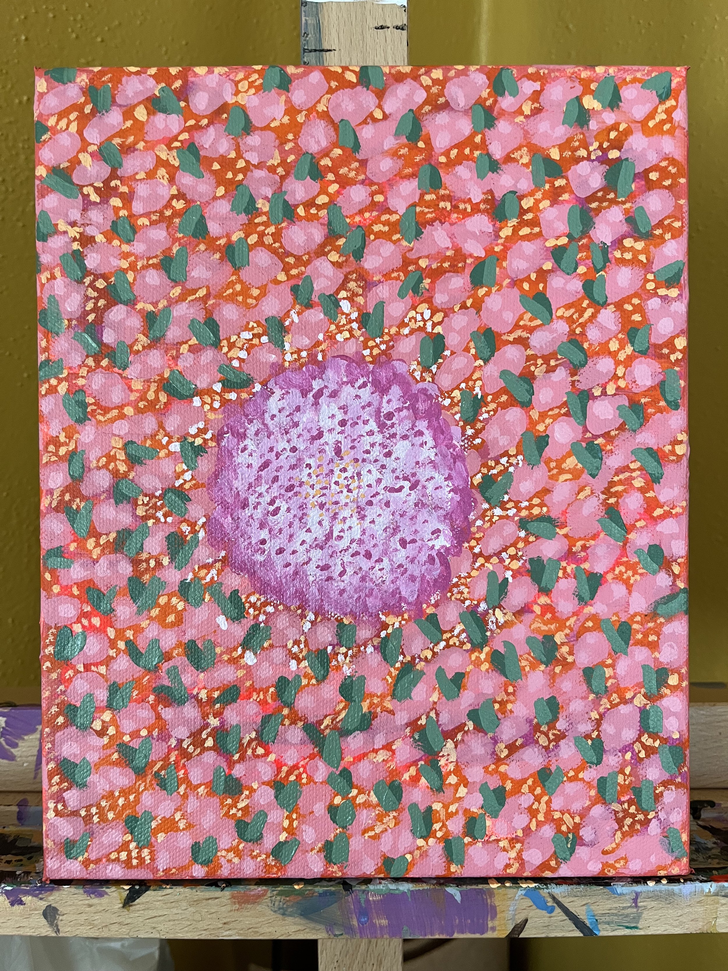 A vibrant abstract painting featuring a pink, purple, and green color palette with numerous pink circles, green shapes, and a large purple circle in the center.