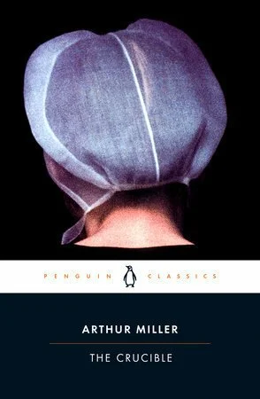 Book cover for 'The Crucible' by Arthur Miller, featuring a person wearing a large, gray, cloth hat covering their head, with only the back of their neck visible.