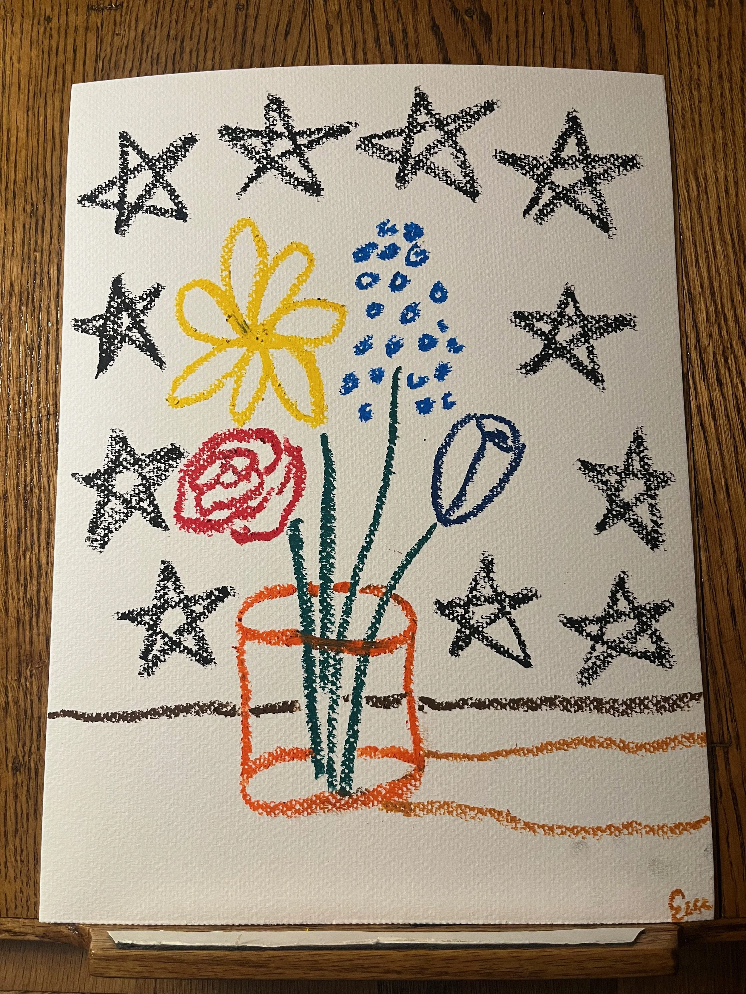 A colorful drawing of a flower bouquet in a vase, surrounded by black stars on a white textured paper background.