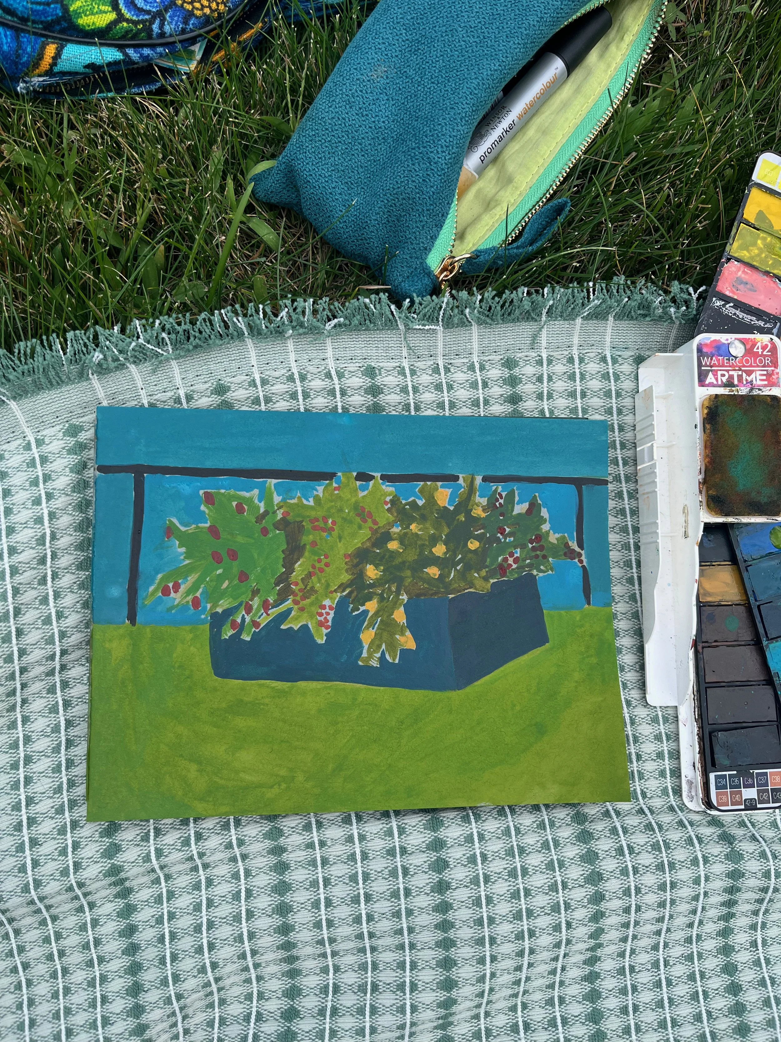 A painting of potted plants, featuring green leaves and red berries, placed on a table with a blue background. Art supplies like watercolors and pens are visible nearby.