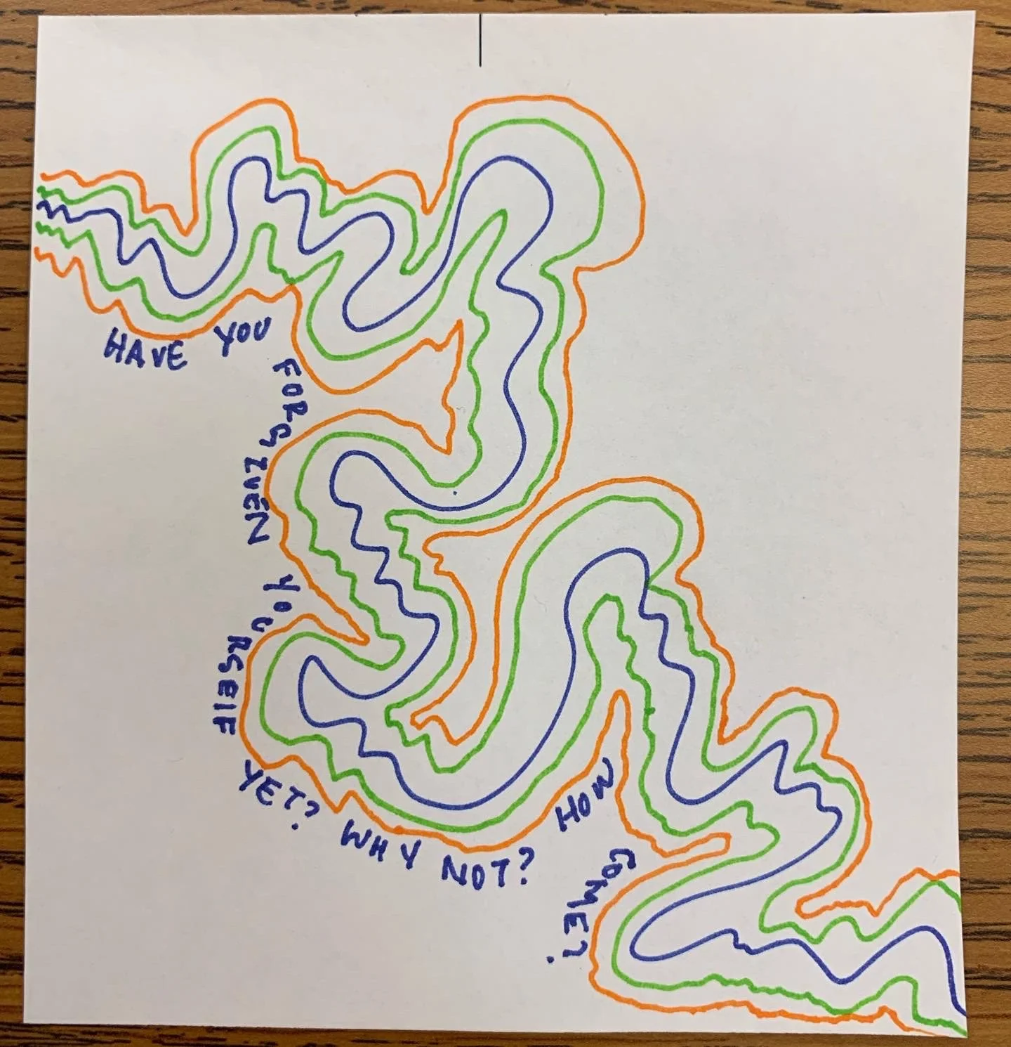 A hand-drawn maze on white paper with green, blue, and orange lines. Blue text on the maze reads: "Have you figured it out yet? Why not?"